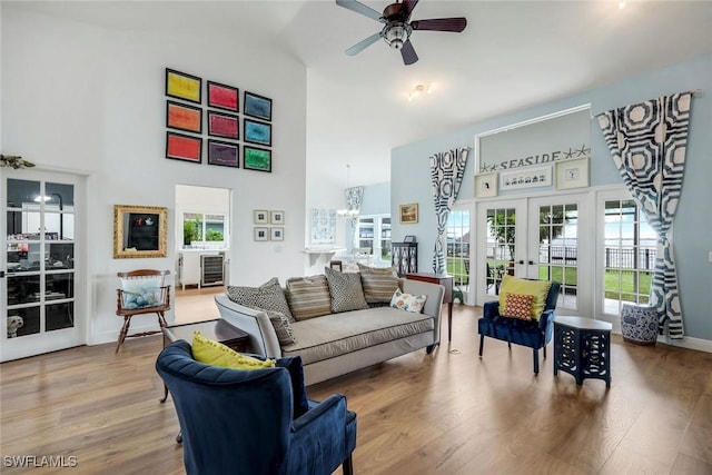 2250 SE 28th St, Cape Coral, FL 33904 - living room with a towering ceiling, french doors, a ceiling fan, wood finished floors, and a chandelier