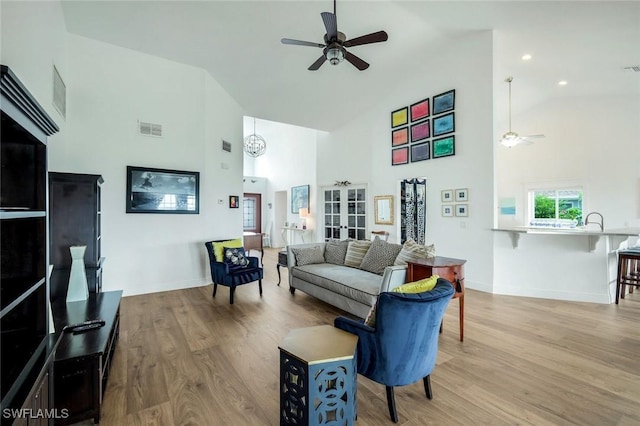 2250 SE 28th St, Cape Coral, FL 33904 - living area with a ceiling fan, high vaulted ceiling, baseboards, and wood finished floors