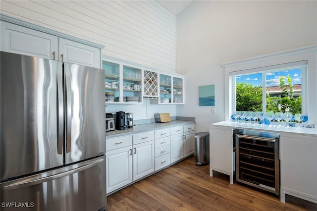 2250 SE 28th St, Cape Coral, FL 33904 - kitchen with freestanding refrigerator, beverage cooler, a towering ceiling, light countertops, and dark wood-style floors