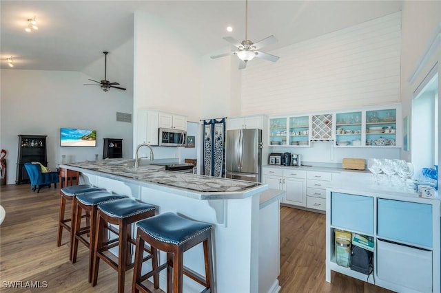 2250 SE 28th St, Cape Coral, FL 33904 - kitchen with appliances with stainless steel finishes, ceiling fan, a kitchen bar, white cabinets, and high vaulted ceiling