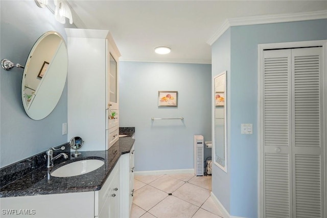 2250 SE 28th St, Cape Coral, FL 33904 - bathroom featuring a closet, vanity, crown molding, baseboards, and tile patterned flooring