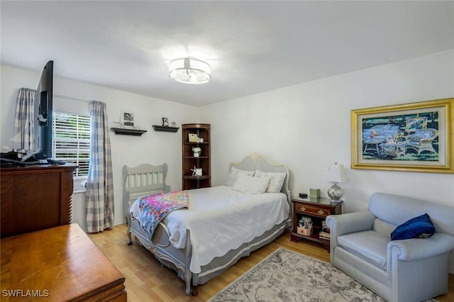 2250 SE 28th St, Cape Coral, FL 33904 - bedroom with light wood-type flooring and a chandelier