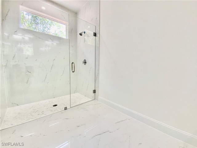2710 21st St W, Lehigh Acres, FL 33971 - bathroom with a marble finish shower, baseboards, and marble tiled floors