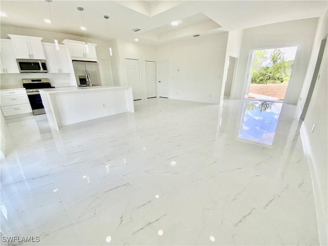 2710 21st St W, Lehigh Acres, FL 33971 - unfurnished living room with light marble finish flooring and recessed lighting