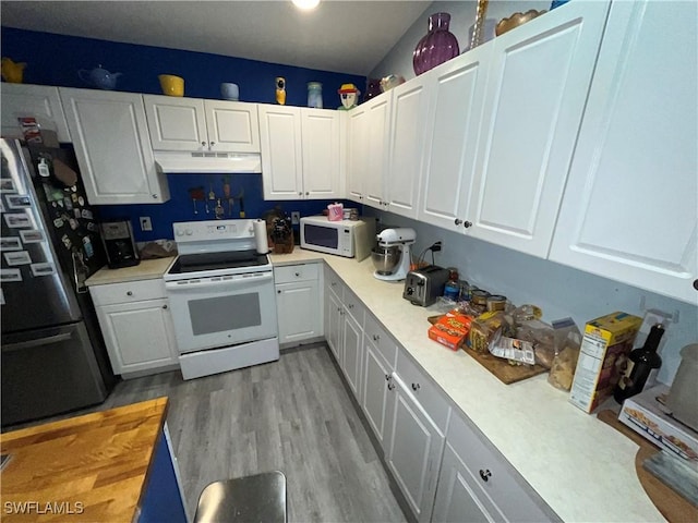 4767/4765 22nd St SW, Lehigh Acres, FL 33973 - kitchen with white appliances, under cabinet range hood, light countertops, and white cabinetry