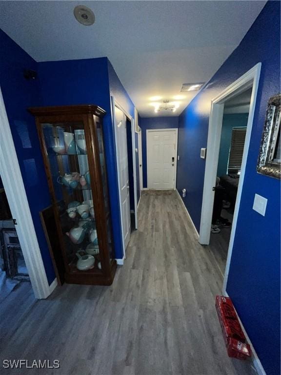 4767/4765 22nd St SW, Lehigh Acres, FL 33973 - hallway featuring wood finished floors and baseboards