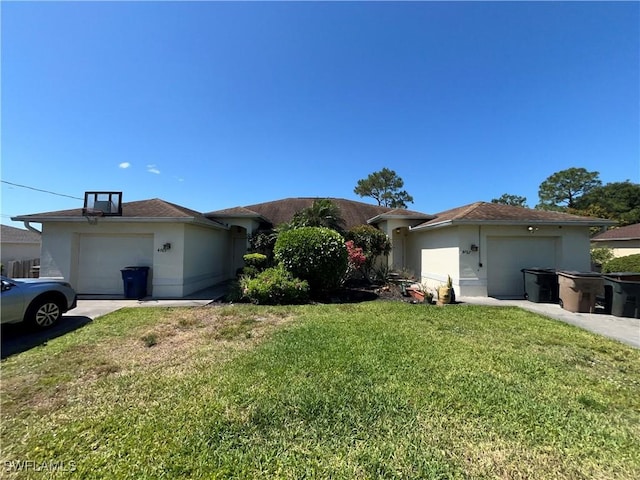 4767/4765 22nd St SW, Lehigh Acres, FL 33973 - ranch-style home featuring a garage, a front yard, stucco siding, and driveway