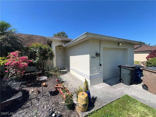 4767/4765 22nd St SW, Lehigh Acres, FL 33973 - view of home's exterior with stucco siding and a garage