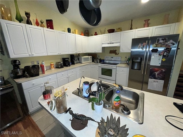 4767/4765 22nd St SW, Lehigh Acres, FL 33973 - kitchen featuring white appliances, light countertops, white cabinets, and under cabinet range hood