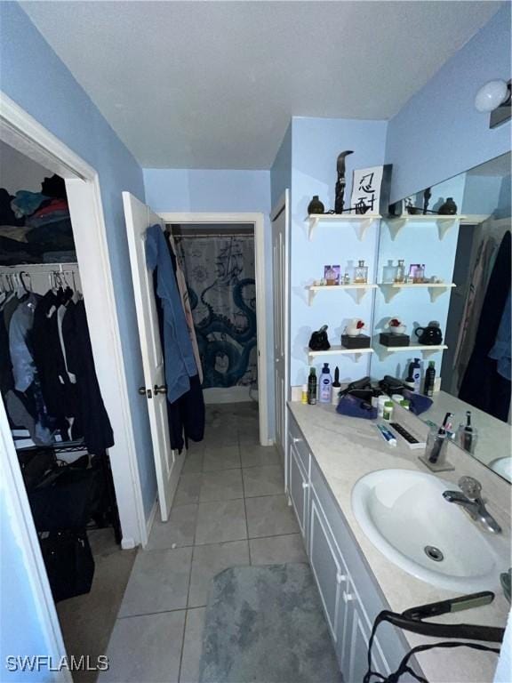 4767/4765 22nd St SW, Lehigh Acres, FL 33973 - bathroom with tile patterned floors, vanity, and a walk in closet