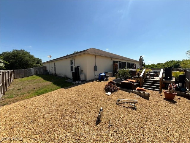 4767/4765 22nd St SW, Lehigh Acres, FL 33973 - back of house with stucco siding, a fenced backyard, and a deck