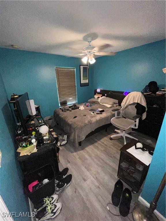 4767/4765 22nd St SW, Lehigh Acres, FL 33973 - bedroom featuring wood finished floors, a ceiling fan, and baseboards