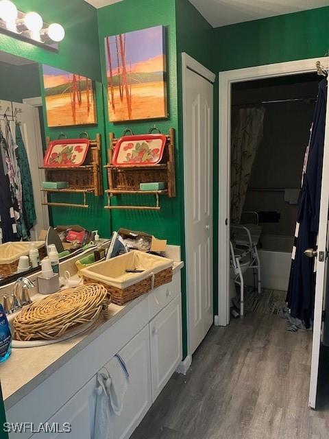 4767/4765 22nd St SW, Lehigh Acres, FL 33973 - full bath with wood finished floors, a bathtub, vanity, and curtained shower