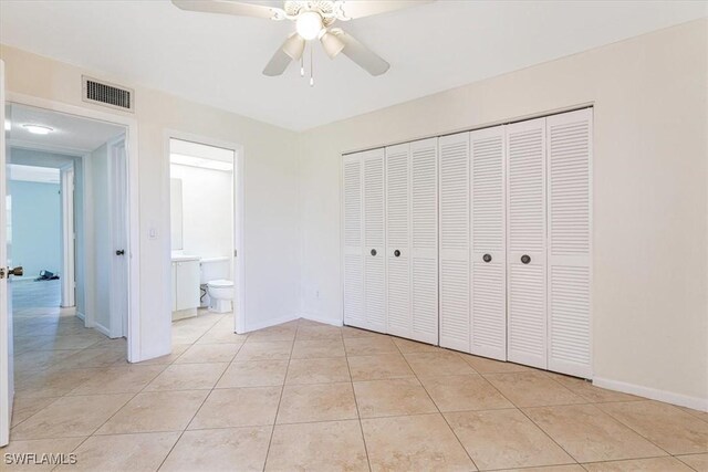 3127 Boca Ciega Dr Unit B6, Naples, FL 34112 - unfurnished bedroom with light tile patterned floors, baseboards, a closet, and ensuite bath