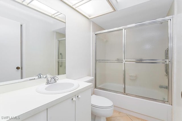 3127 Boca Ciega Dr Unit B6, Naples, FL 34112 - bathroom featuring toilet, vanity, shower / bath combination with glass door, and tile patterned floors