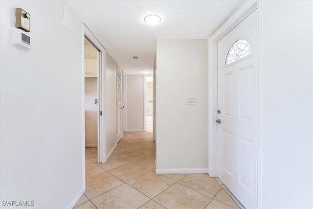 3127 Boca Ciega Dr Unit B6, Naples, FL 34112 - entrance foyer with light tile patterned flooring and baseboards