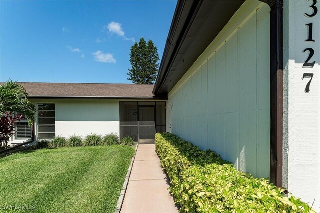 3127 Boca Ciega Dr Unit B6, Naples, FL 34112 - view of exterior entry featuring a yard