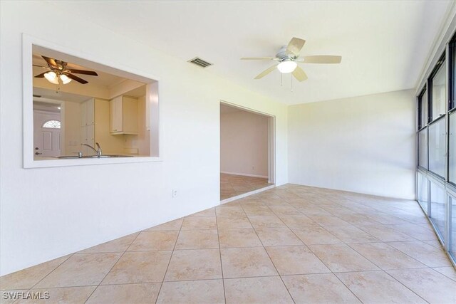 3127 Boca Ciega Dr Unit B6, Naples, FL 34112 - spare room featuring ceiling fan, light tile patterned floors, and a sink