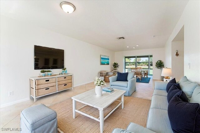 3127 Boca Ciega Dr Unit B6, Naples, FL 34112 - living room featuring light tile patterned floors and baseboards