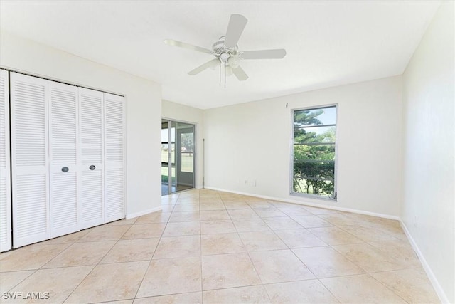 3127 Boca Ciega Dr Unit B6, Naples, FL 34112 - unfurnished bedroom with multiple windows, light tile patterned floors, and a closet