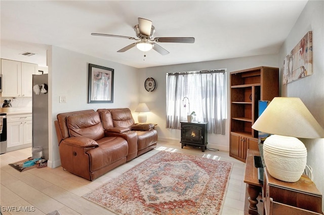2153 Twin Brooks Rd, North Fort Myers, FL 33917 - living room with a wood stove and a ceiling fan