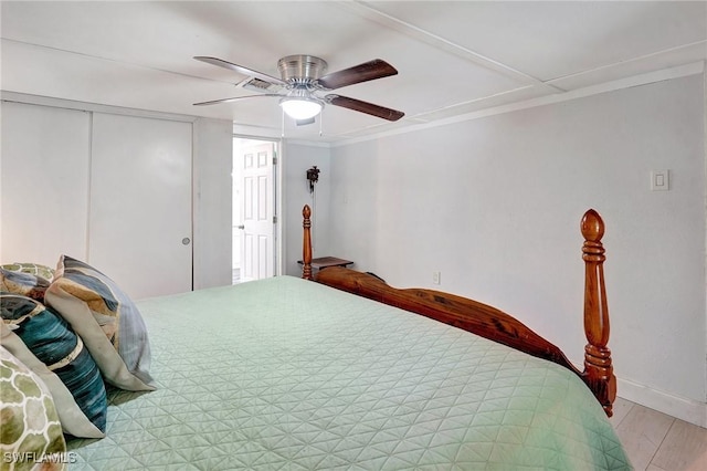 2153 Twin Brooks Rd, North Fort Myers, FL 33917 - bedroom with a closet, baseboards, a ceiling fan, ornamental molding, and light wood-type flooring
