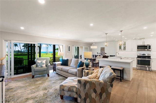 1080 S Collier Blvd Unit 103, Marco Island, FL 34145 - living room featuring recessed lighting, light wood-style flooring, and ornamental molding
