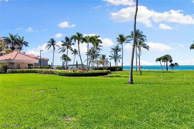 1080 S Collier Blvd Unit 103, Marco Island, FL 34145 - view of community featuring a water view and a lawn