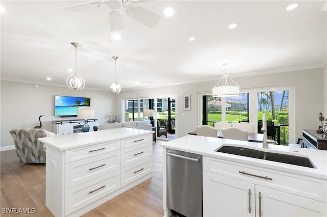 1080 S Collier Blvd Unit 103, Marco Island, FL 34145 - kitchen featuring dishwasher, a sink, crown molding, light countertops, and light wood finished floors