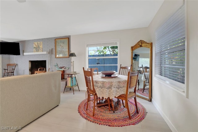 2662 Mangrove St, Naples, FL 34112 - dining room featuring a fireplace, baseboards, and light tile patterned flooring