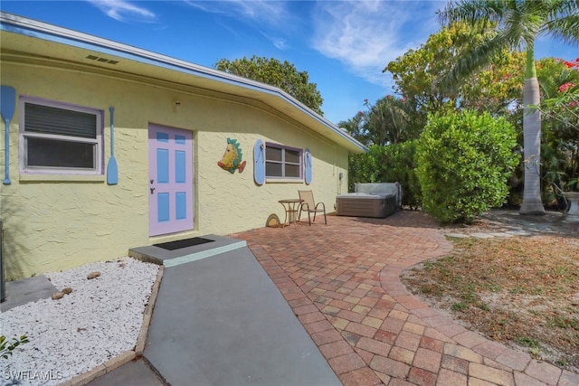 2662 Mangrove St, Naples, FL 34112 - property entrance with stucco siding and a patio