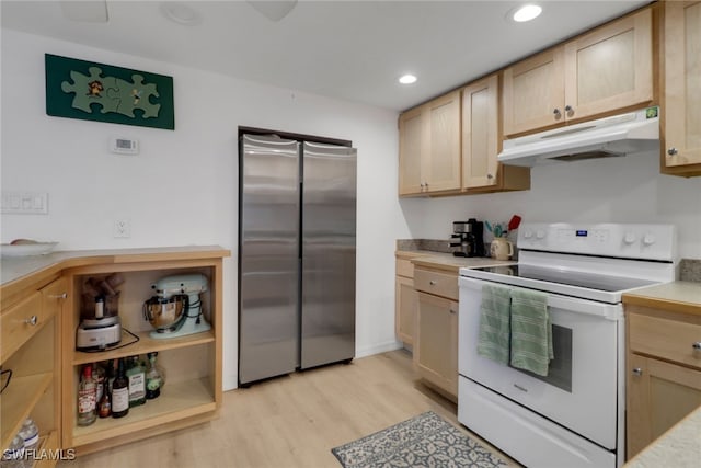 2662 Mangrove St, Naples, FL 34112 - kitchen featuring electric stove, under cabinet range hood, freestanding refrigerator, light wood-style floors, and light countertops