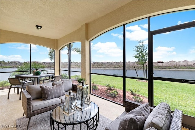 14826 Birchwood Ct Unit 6711, Punta Gorda, FL 33955 - sunroom / solarium featuring a water view, carpet, an outdoor hangout area, a textured ceiling, and plenty of natural light