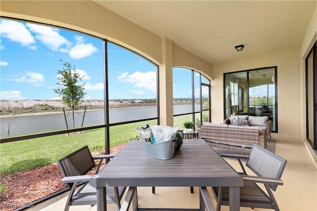 14826 Birchwood Ct Unit 6711, Punta Gorda, FL 33955 - sunroom / solarium with a water view, a textured wall, and outdoor dining space