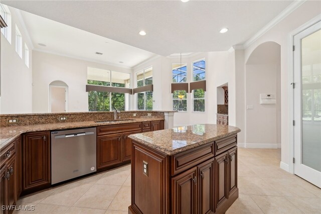 19292 La Serena Dr, Estero, FL 33967 - kitchen with stainless steel dishwasher, a sink, arched walkways, light tile patterned flooring, and crown molding