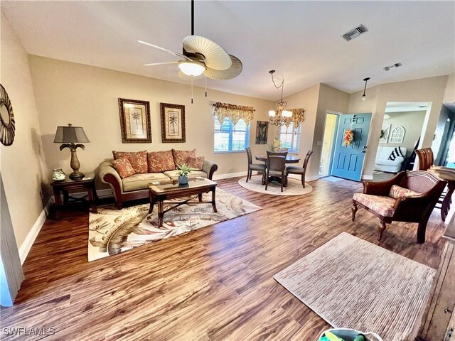 9317 Aegean Cir, Lehigh Acres, FL 33936 - living area featuring wood finished floors, baseboards, a ceiling fan, a chandelier, and lofted ceiling