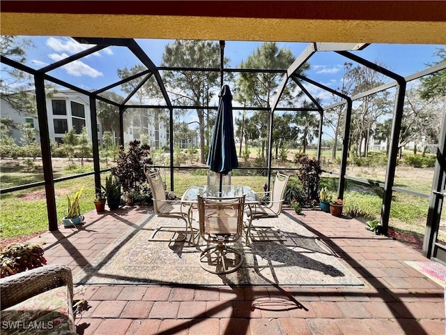 9317 Aegean Cir, Lehigh Acres, FL 33936 - view of patio / terrace with outdoor dining area and glass enclosure