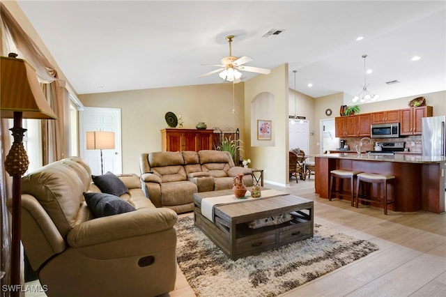 516 SE 14th Ter, Cape Coral, FL 33990 - living area with lofted ceiling, a ceiling fan, and light wood-style floors
