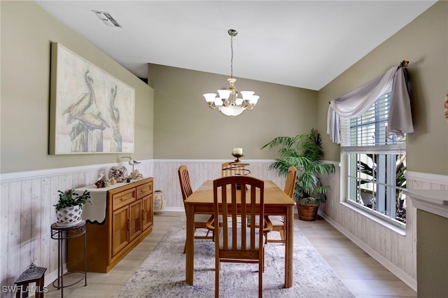 516 SE 14th Ter, Cape Coral, FL 33990 - dining room with wainscoting, light wood-style floors, a chandelier, and wooden walls