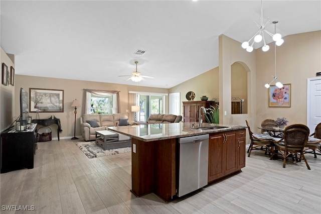 516 SE 14th Ter, Cape Coral, FL 33990 - kitchen featuring stainless steel dishwasher, a sink, lofted ceiling, a kitchen island with sink, and light wood-style floors