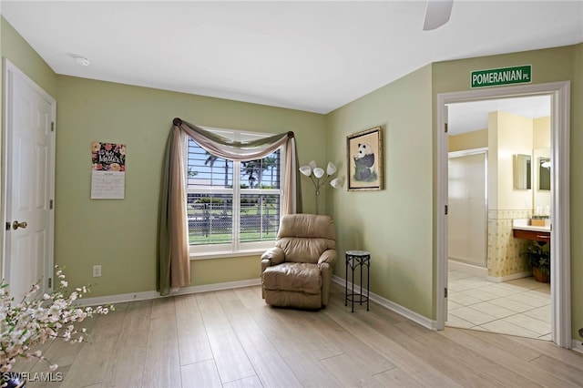 516 SE 14th Ter, Cape Coral, FL 33990 - living area featuring light wood finished floors, baseboards, and ceiling fan