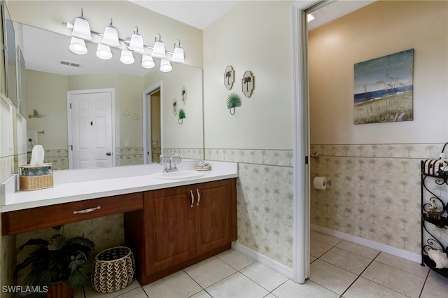 516 SE 14th Ter, Cape Coral, FL 33990 - bathroom featuring wainscoting, vanity, and tile patterned flooring