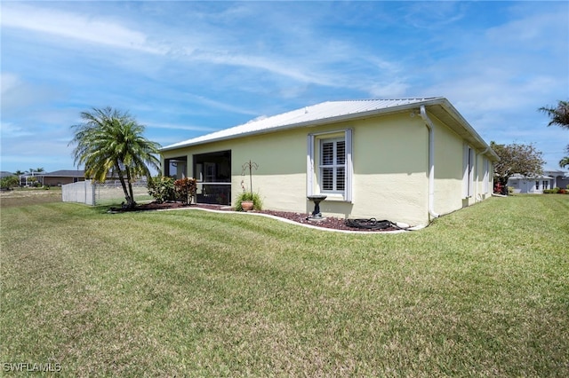 516 SE 14th Ter, Cape Coral, FL 33990 - rear view of house with stucco siding, a yard, a sunroom, and metal roof
