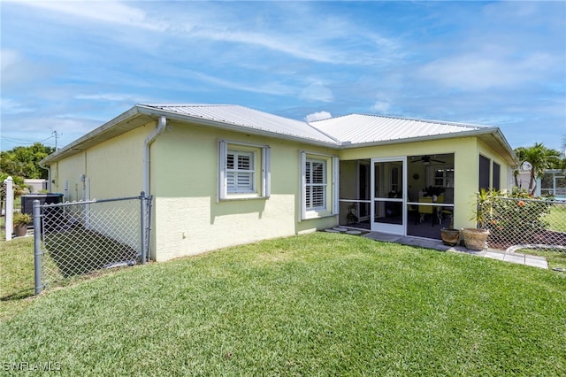 516 SE 14th Ter, Cape Coral, FL 33990 - back of house with a sunroom, stucco siding, metal roof, and a ceiling fan