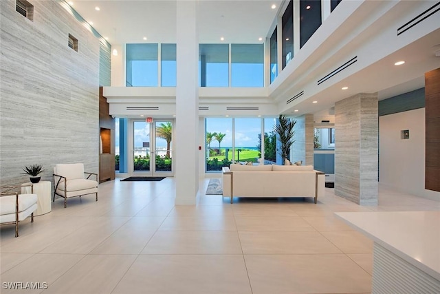 3443 Gulf Shore Blvd N Unit 409, Naples, FL 34103 - lobby with a towering ceiling, tile walls, and recessed lighting