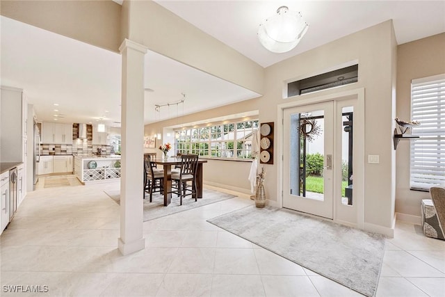 13461 Bridgeford Ave, Bonita Springs, FL 34135 - foyer featuring light tile patterned flooring, healthy amount of natural light, and baseboards