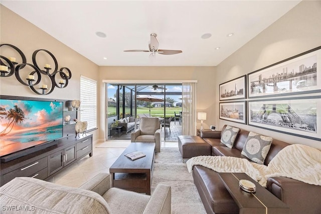 13461 Bridgeford Ave, Bonita Springs, FL 34135 - living area with a ceiling fan, light tile patterned floors, and baseboards