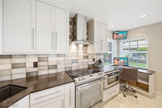 13461 Bridgeford Ave, Bonita Springs, FL 34135 - kitchen with wall chimney exhaust hood, electric stove, dark countertops, white cabinets, and recessed lighting