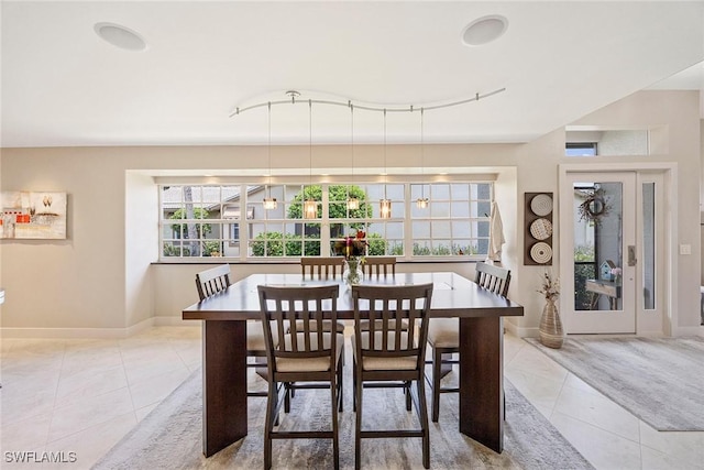 13461 Bridgeford Ave, Bonita Springs, FL 34135 - tiled dining space with baseboards and rail lighting