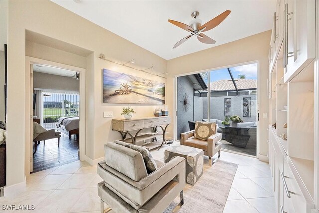 13461 Bridgeford Ave, Bonita Springs, FL 34135 - living area featuring healthy amount of natural light, a ceiling fan, light tile patterned flooring, and baseboards